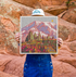 A vibrant, multicolored giclee print featuring a Mount Rainier landscape with trees and a sun in the background.