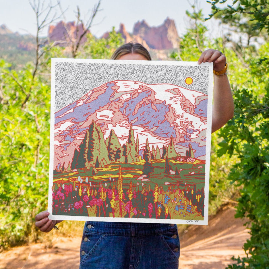A vibrant, multicolored giclee print featuring a Mount Rainier with trees and a sun in the background.
