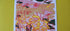 Physical print shown on top of a chartreuse felt fabric. There is a green plant leaf at the top of the frame overlapping the top of the print.